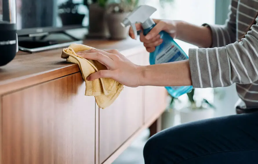Wiping down a finished cabinet door with soap and water