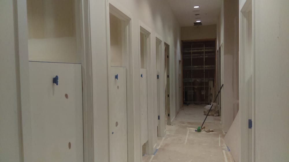 Retail fitting rooms in Austin before painting
