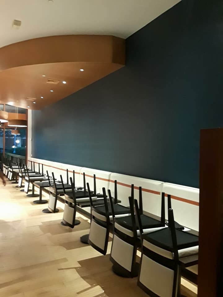 Restaurant interior with navy accent wall painted in Austin