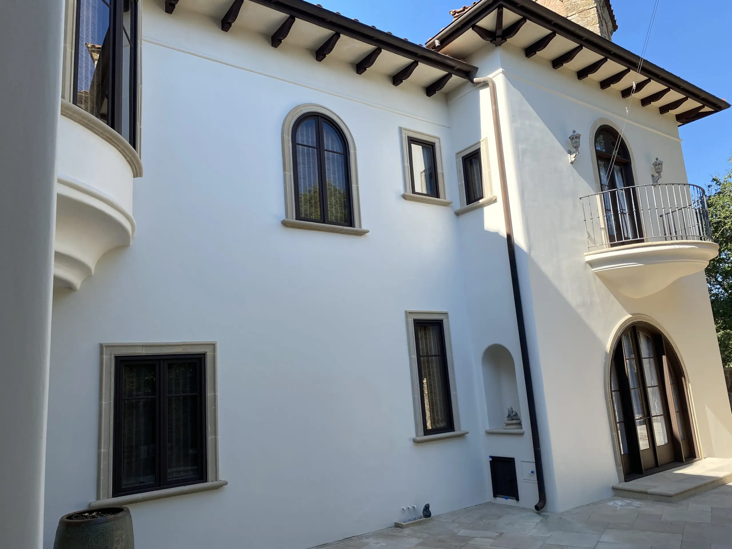 Finished exterior stucco repaint on a Barton Creek home in Austin