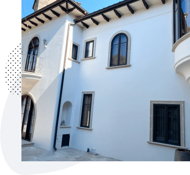 Exterior residential painting in Austin, freshly painted white Mediterranean home