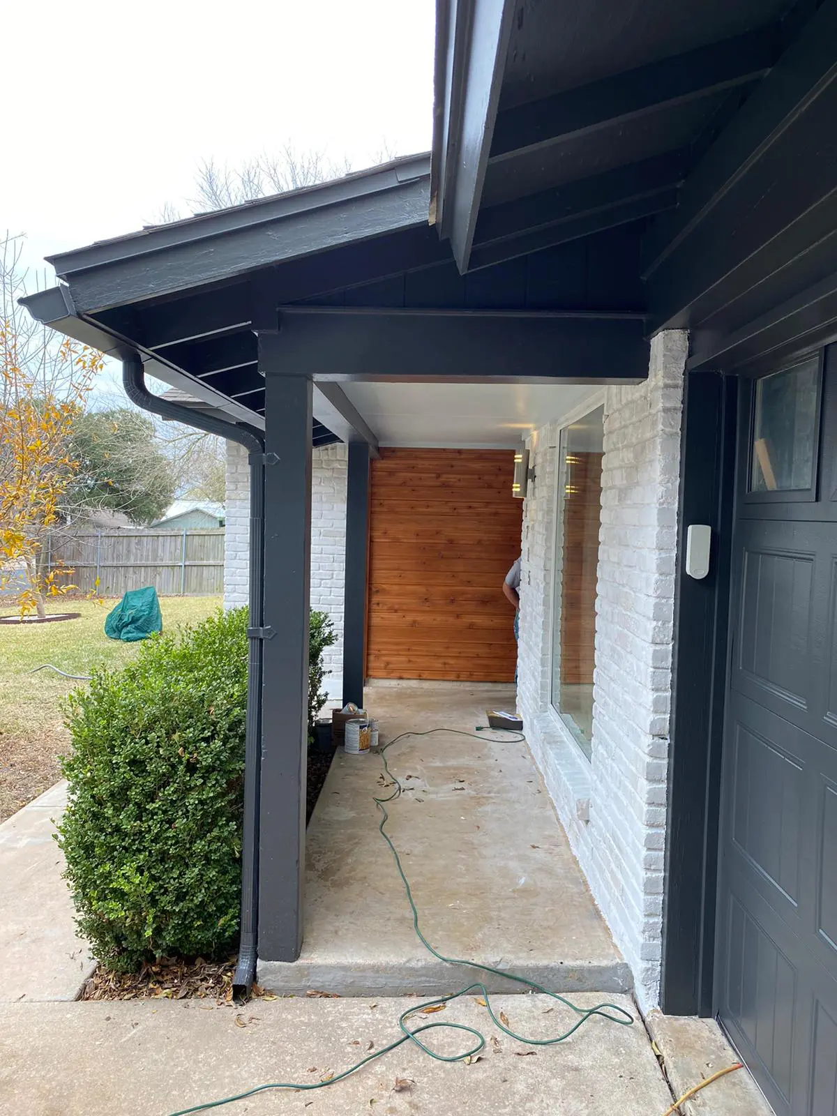 Limewashed brick and cedar entry on an Austin home