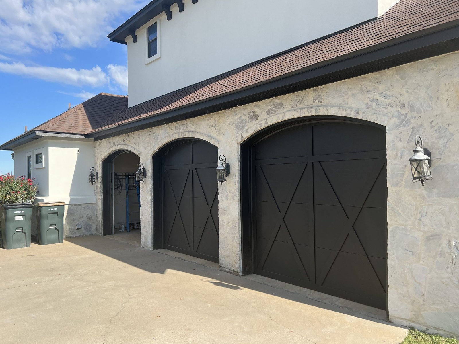 Limewashed stucco garage with carriage doors in Austin