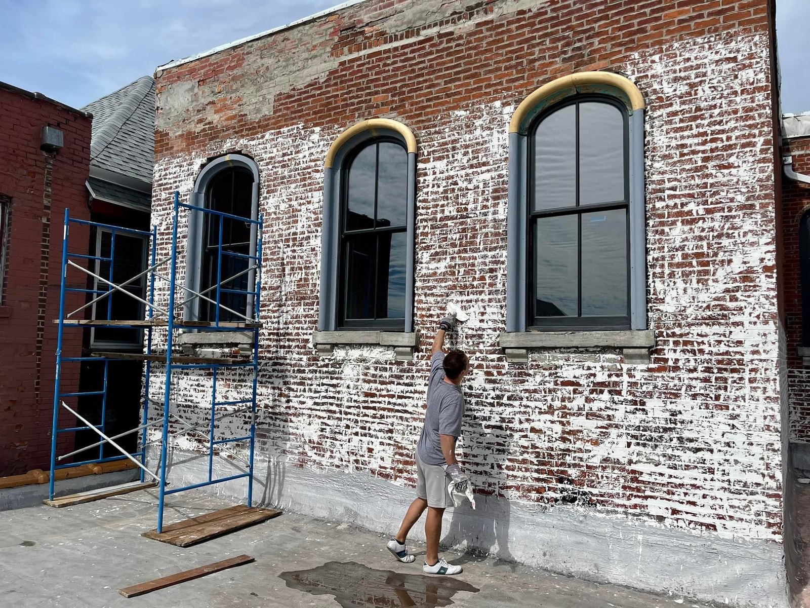 Historic brick building being limewashed in Austin