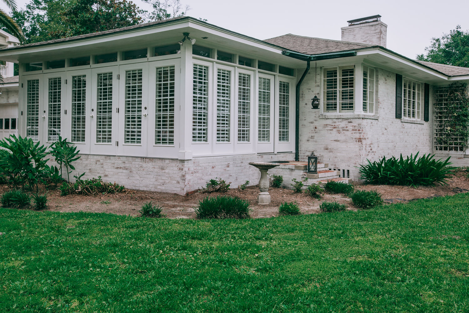 Limewashed ranch home with sunroom in Austin