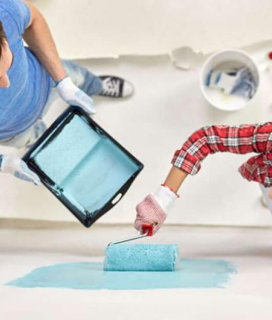 Austin Professional Painting crew rolling out a floor together